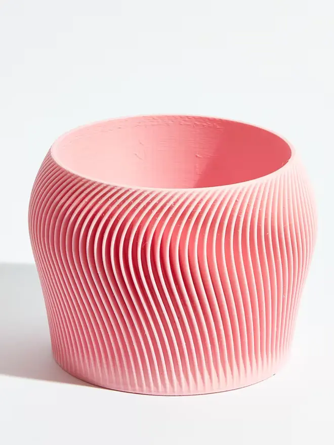 Sustainable 3D Printed Sakura Pink Plant Pot, orbital design against a white background. 