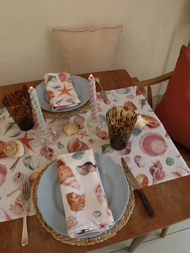 Table dressed with linens printed with shells