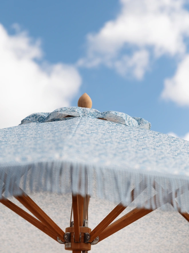Indian Block Print Parasol. A close up of a blue and white parasol 