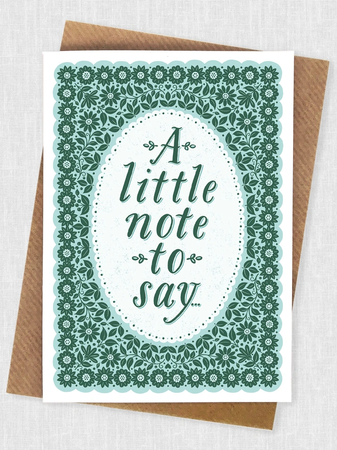 green floral pattern notecard with a little note to say with brown kraft envelope