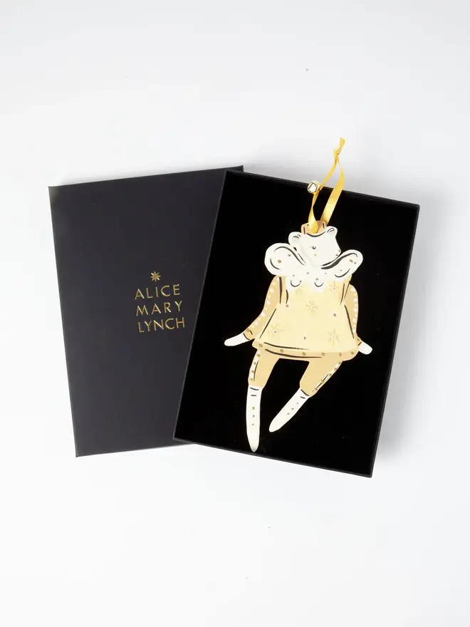 Honey Tree Dancer. wooden hanging bear decoration in an open black gift box embossed "alice mary lynch" in gold, with fairy wings and a gold star-patterned dress, yellow ribbon with a jingle bell