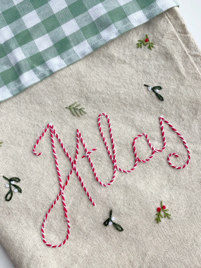 Hand embroidered Christmas stocking with the name Atlas