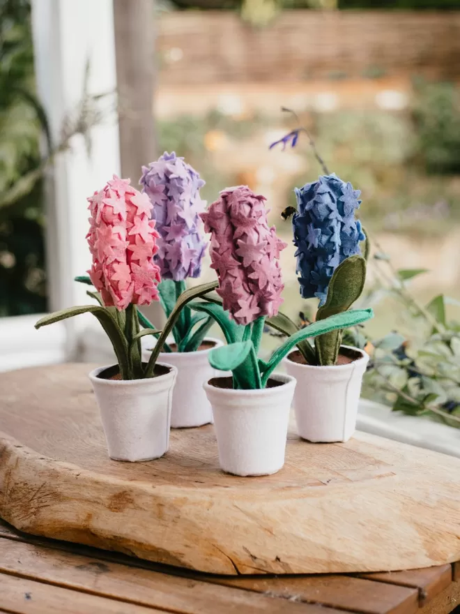 Little Egg Faux felt Hyacinth Plants seen with a bee outside.