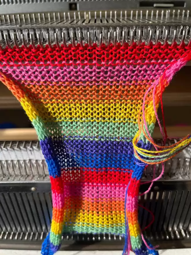 knitting the fabric of a rainbow dog bow tie