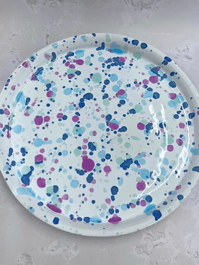 Sweetpea Dinner Plate, a colourful dinner plate placed on a stone surface.