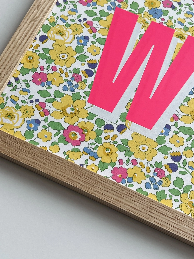 Personalised framed word/name picture in neon pink with white highlights on Liberty Betsy yellow fabric - close up