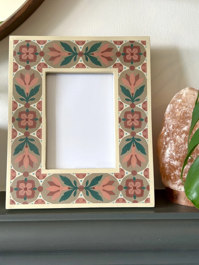 Hand painted folk art style patterned  photo frame in shades of pink, green, cream and light brown