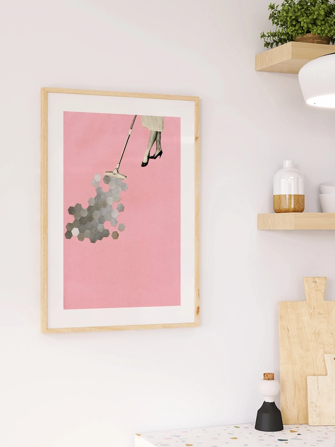 A retro print featuring a woman hoovering up geometric shapes.