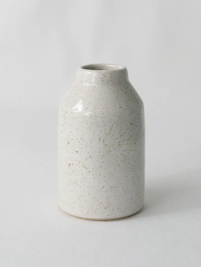 Classic Bud Vase, a colourful ceramic vase sitting on a plain surface against a white backdrop. 