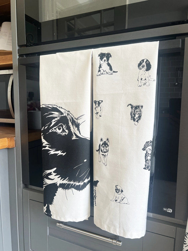 folded Labrador tea towel hanging over a oven door