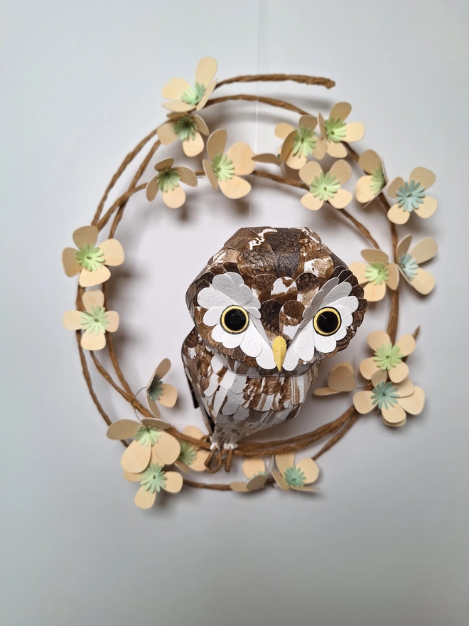 boreal owl sculpture on a floral wreath