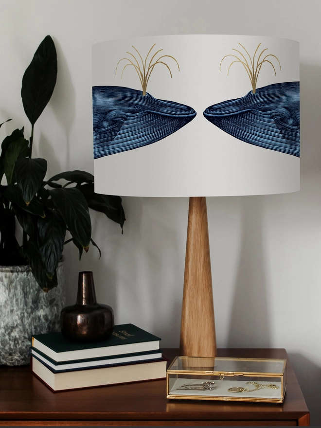 Handmade blue whale lampshade with gold details featuring vintage inspired ocean artwork