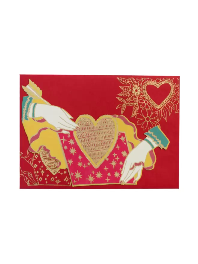 White cut-out shot: red and gold card with hands and matching red envelope