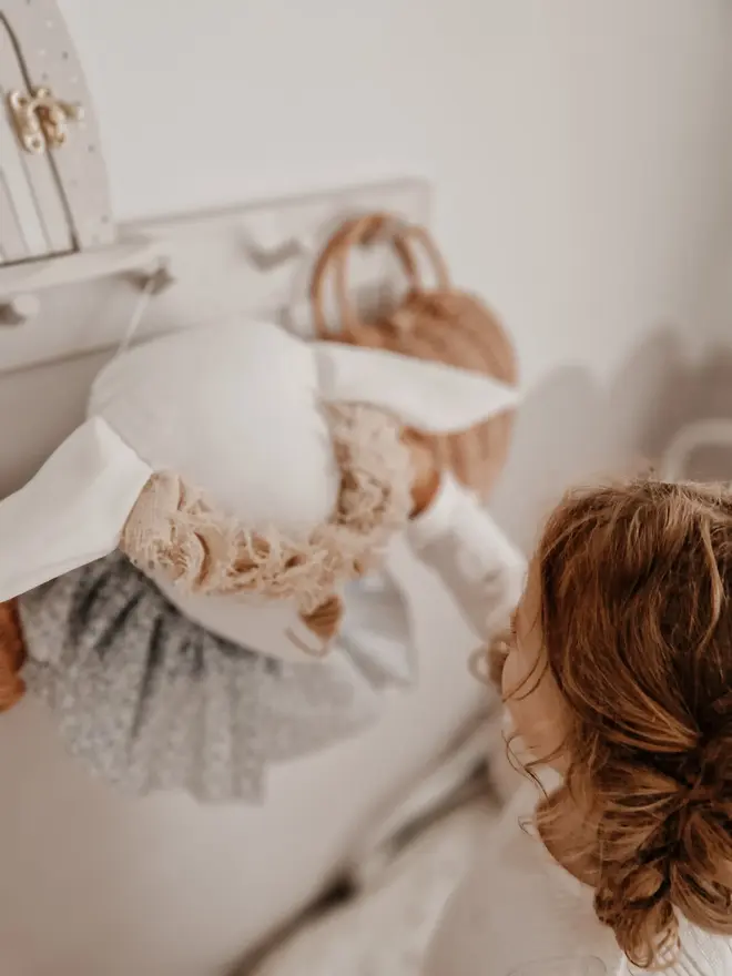 Sheep Head Wall Mount, a hanging sheep head decoration sitting against a plain wall in child's bedroom. 