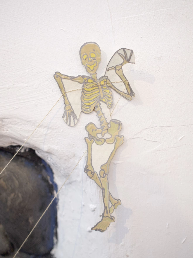 Up close shot of skeleton hanging on white wall
