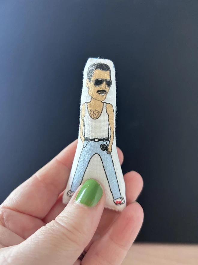 Mini fabric doll of Freddie Mercury.