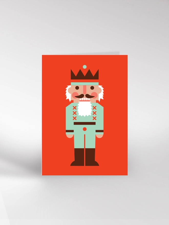 Contemporary illustrated Christmas card featuring a traditional nutcracker