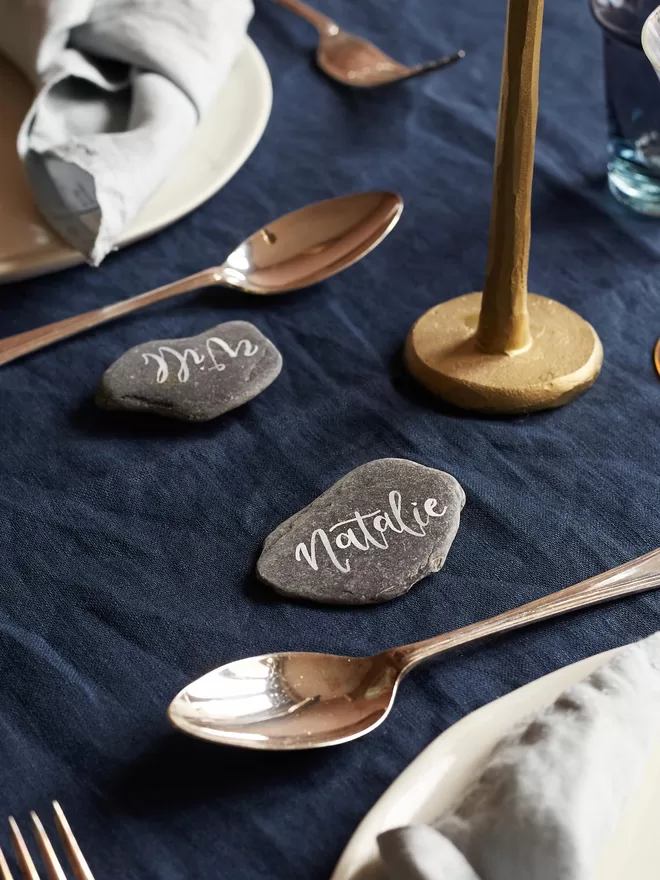 slate name card with calligraphy on table