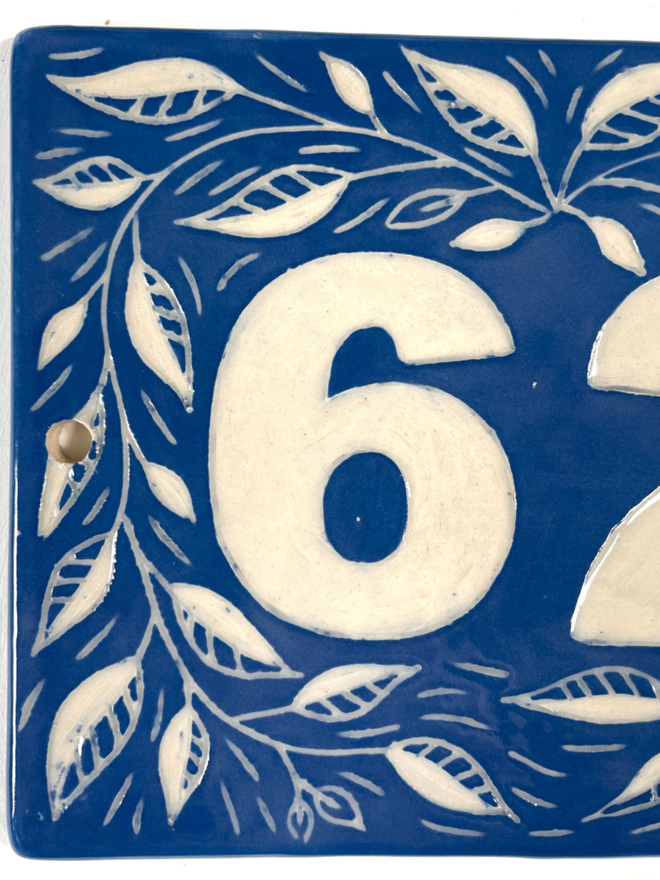 Personalised Ceramic House Number Leaf Tile. A tile in blue.