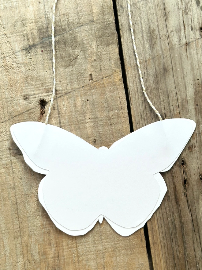 Hand Painted Butterfly Colourful Linocut Hanging Decoration this photo shows the backs which are white with the twine hanging above