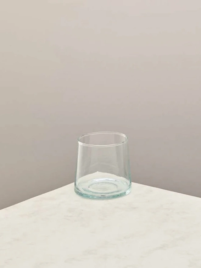 Low Glasses (Set Of 1 Or 4), a low glass sitting on a white counter top against a plain backdrop. 