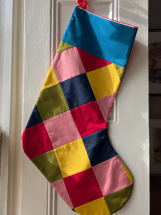 Harlequin Patchwork Stocking, hanging. 