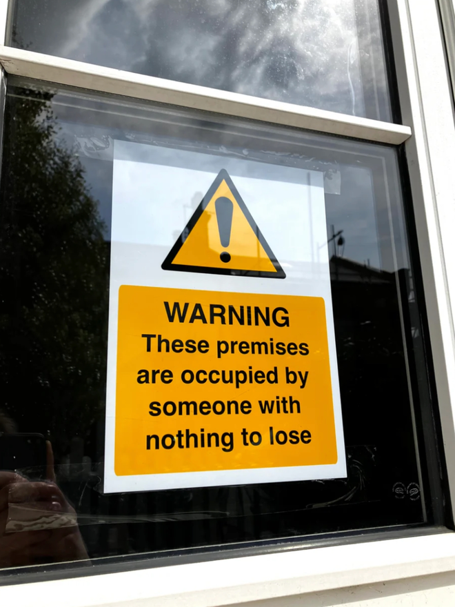 Warning Photo Print. The print in a window.