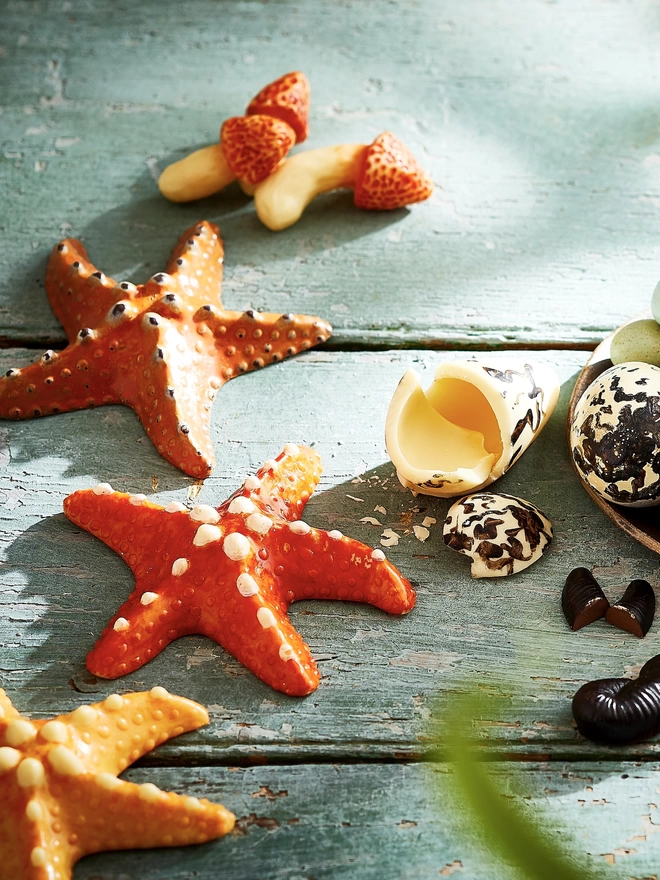 Realistic edible chocolate starfish arranged on a table