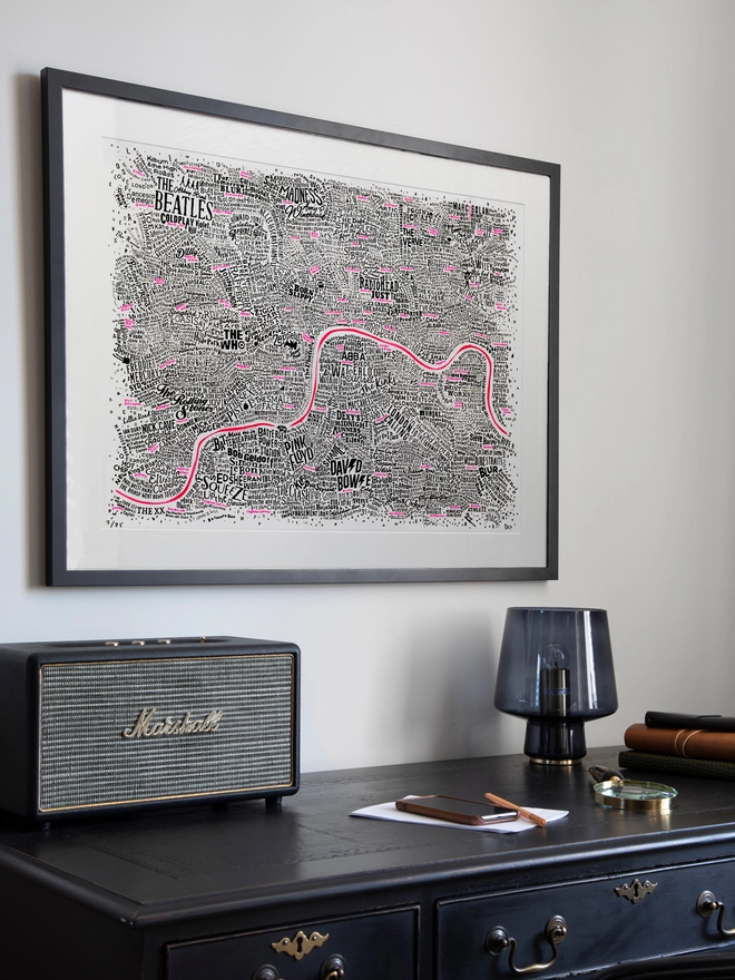 The Music Map of London on a wall next to a desk