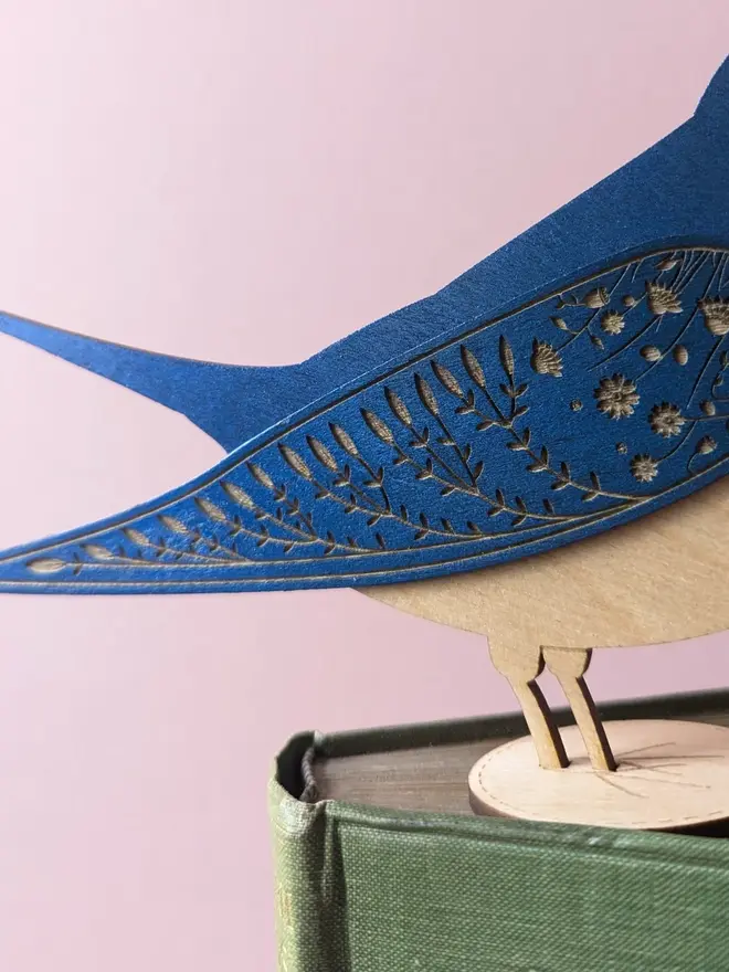 Standing Wooden Barn Swallow, blue wooden bird decoration standing on book. 