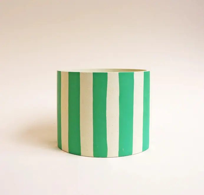 Large Stripes Jesmonite Pot. White ceramic pot decorated with vertical green stripes against a plain light background.