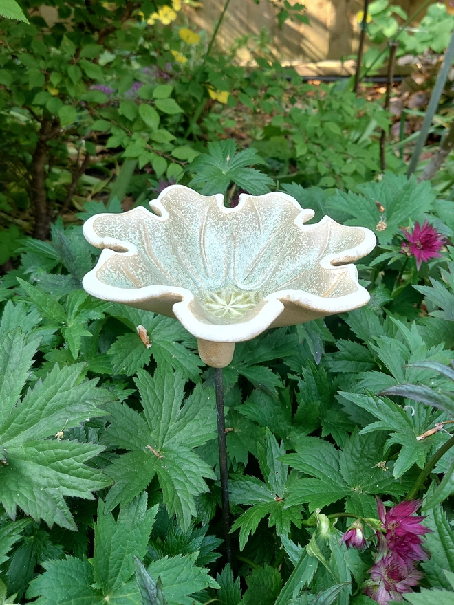 Seven petal ceramic flower bird bath on brass rod