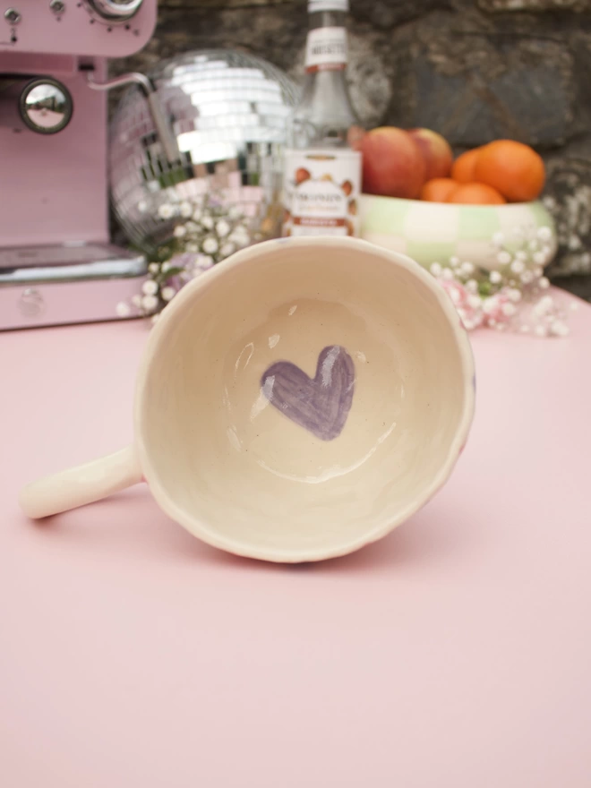 Inside bottom of mug is a painted purple heart