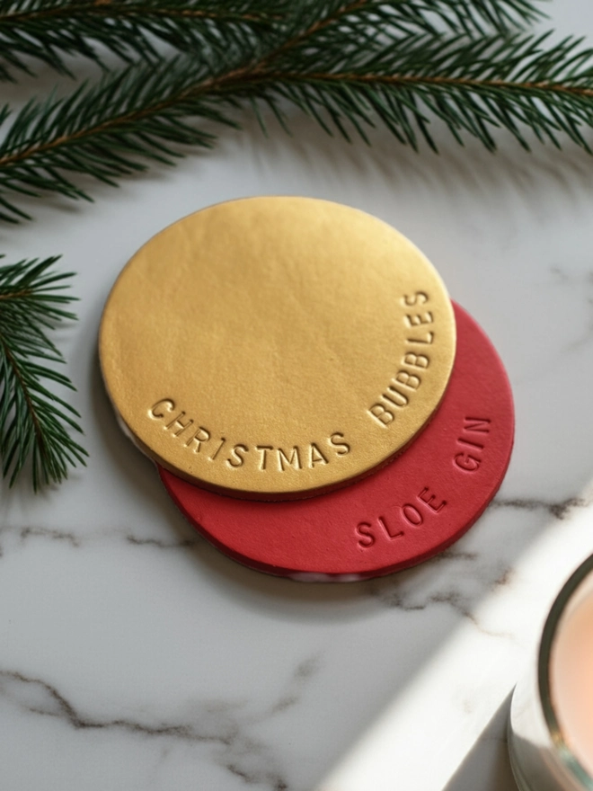 Christmas Bubbles Handstamped in gold on a leather coaster