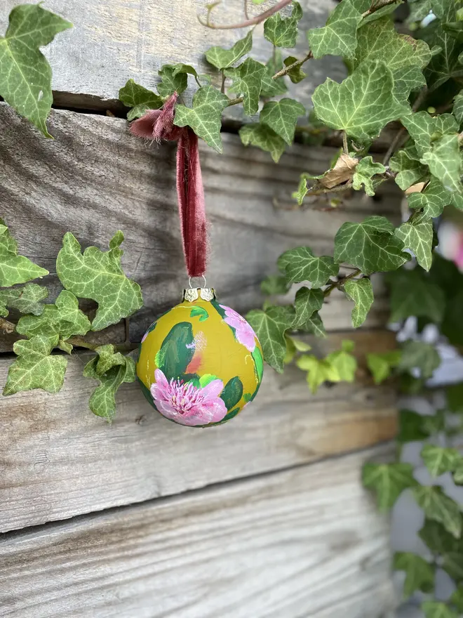 Unique hand-painted ceramic floral bauble featuring pink paeonia flowers on a olive green background