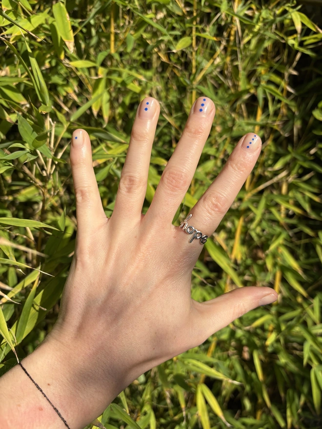 Ring that says 'Hope' within it, in Sterling Silver on the hand