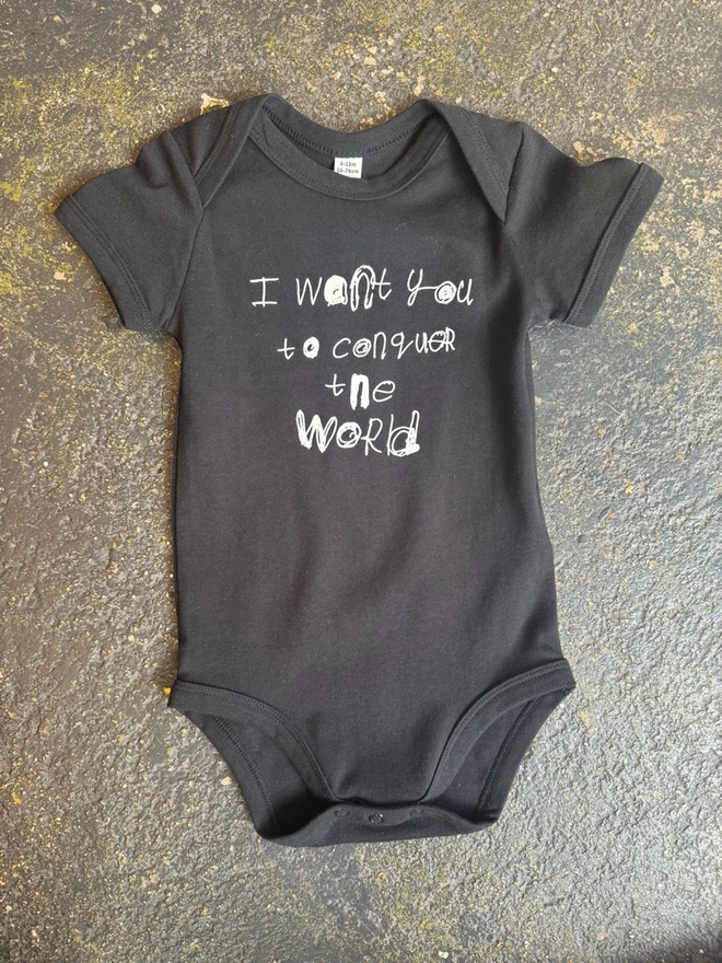 Black baby grow with Pipers white unique font on the front