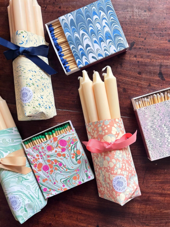 Wrapped Candles & Square Matchbox. A selection of the three colours of matchbox available with corresponding wrapped candles in pink, green and blue.