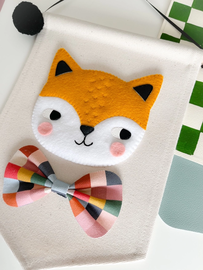 Mustard hand sewn fox banner on a cream banner