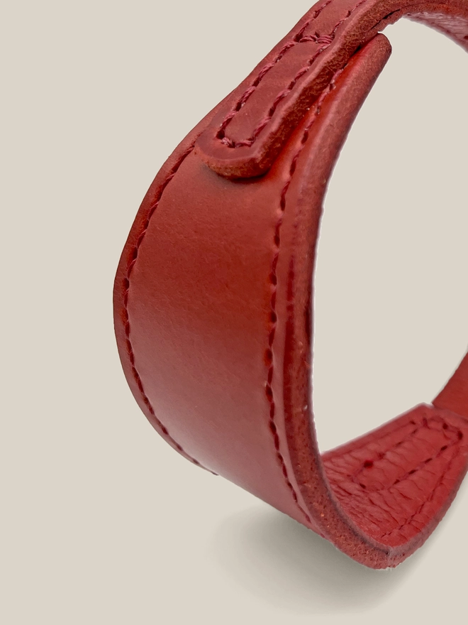 close up of stitching for a red sighthound collar