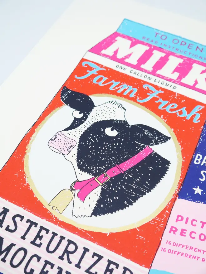 Milk Carton Cow Screenprint Daisy's Finest, a colourful milk carton design on a white screenprint. It sits on a baby blue backdrop. 