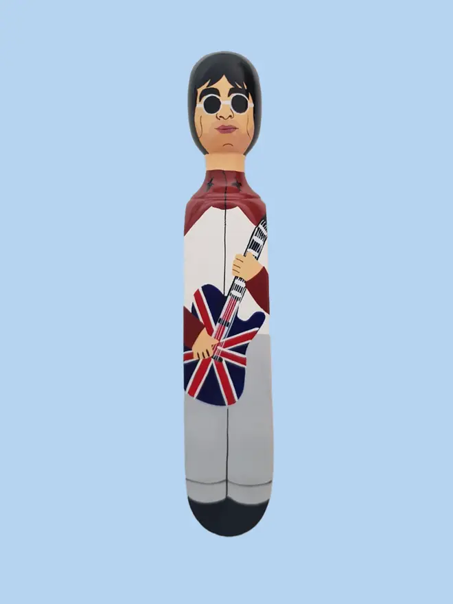 Wooden Door Stopper (Our Noel), a colourful wooden door stop sitting on a white surface. 