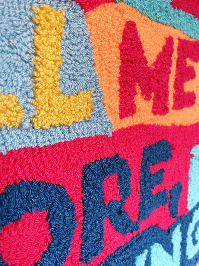 close up detail showing the type and stitches of the punch needle art piece