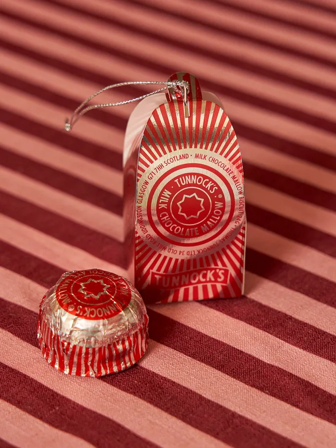Tunnock's Tea Cake Christmas Bauble on a red striped tablecloth