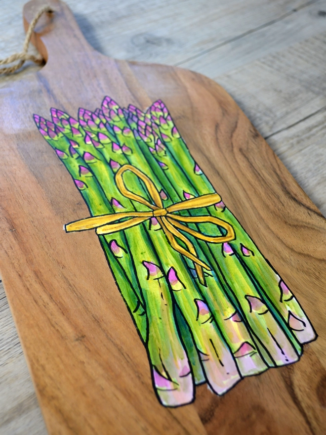 Wooden serving board with handpainted asparagus design