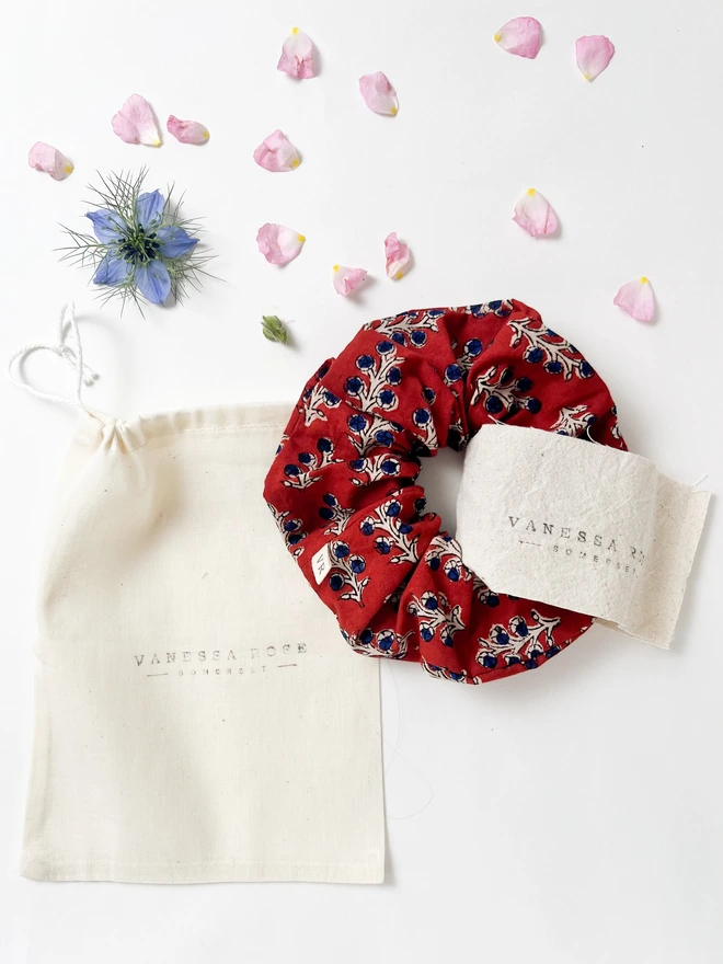 Red block print hair scrunchie on the bag it comes in