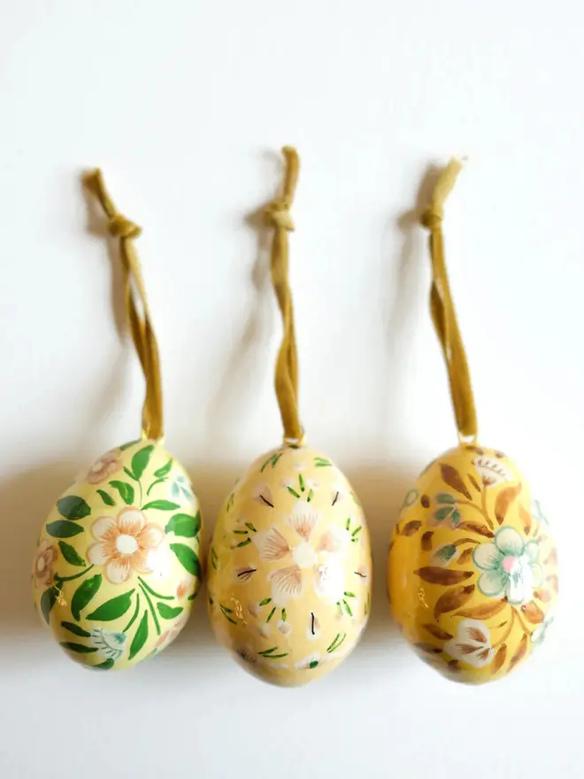 Group shot of hand painted decorative eggs with velvet string