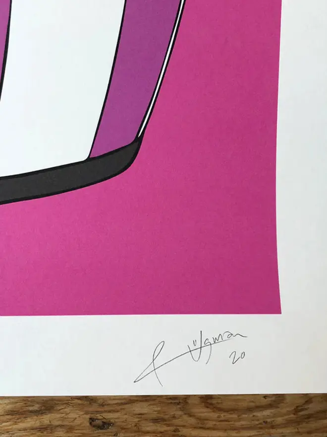 Motor cycle helmet with a star-and-stripe design on a pink background. 