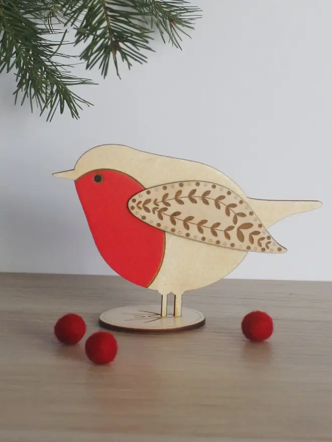 Standing Wooden Robin, red wooden bird decoration standing on a platform. 