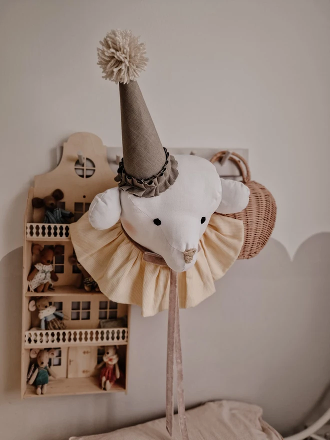 Bear Head Nursery Decoration, a bear decoration sitting against a wall in a child's decorated bedroom. 